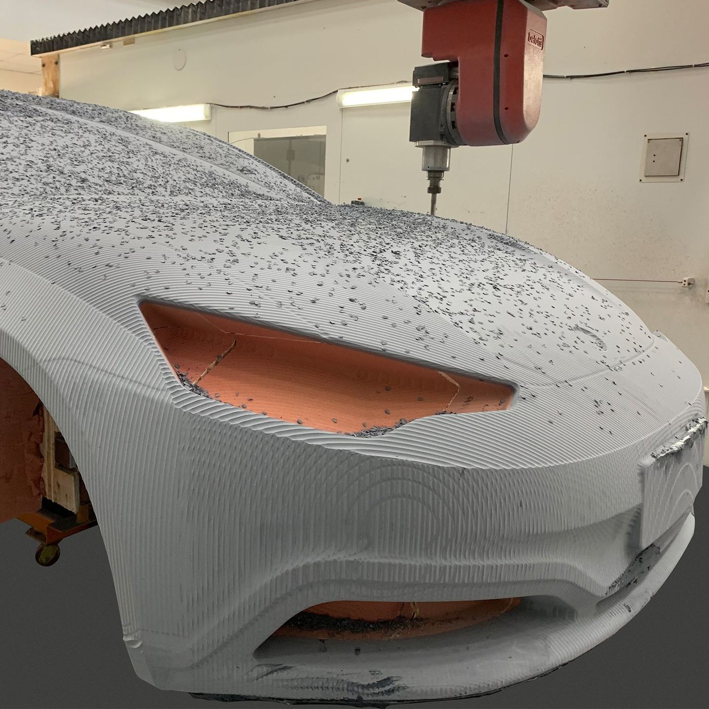 Machined foam body held with clamping points in the machining bay