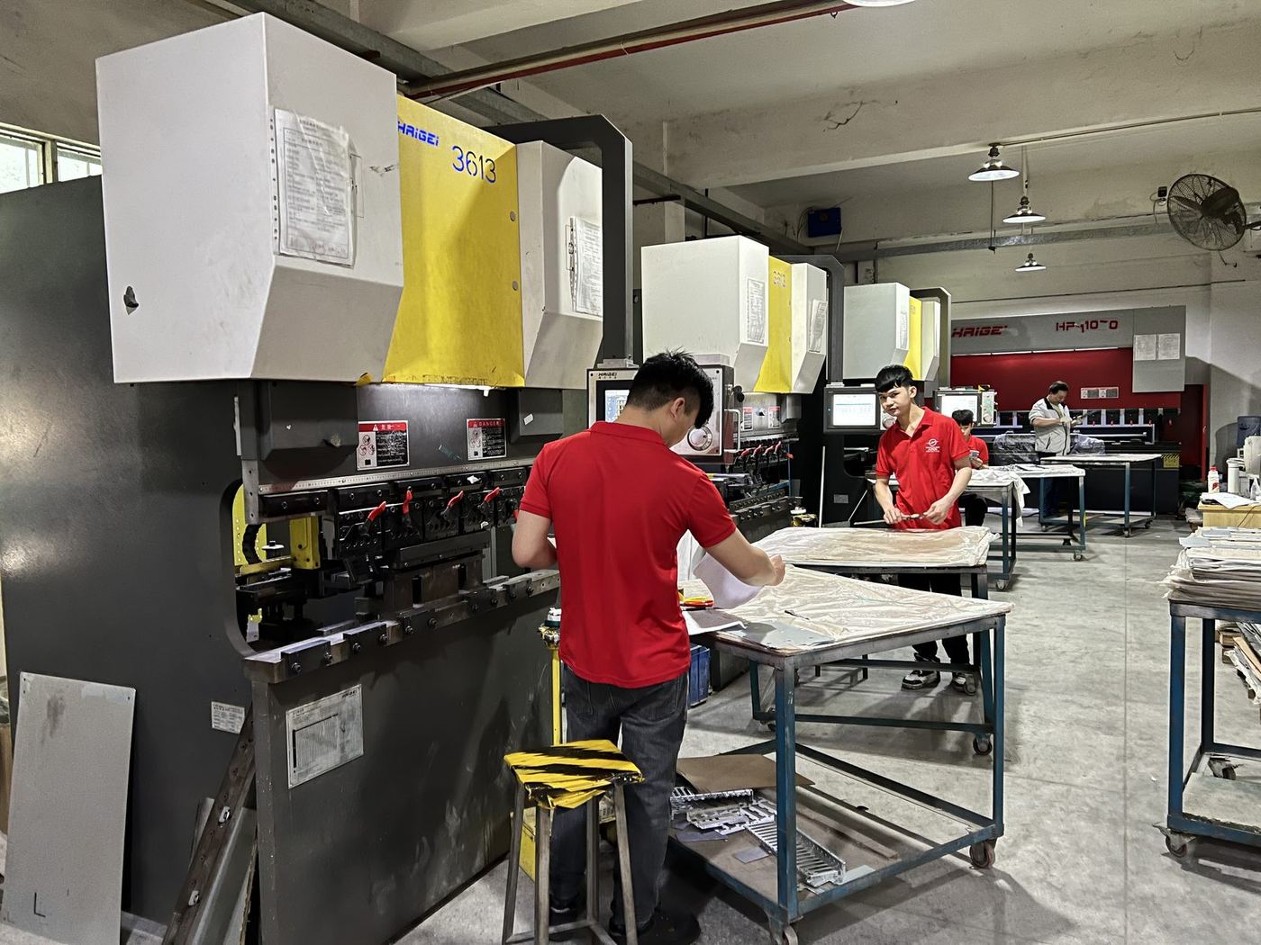 Operators setting a CNC bending machine